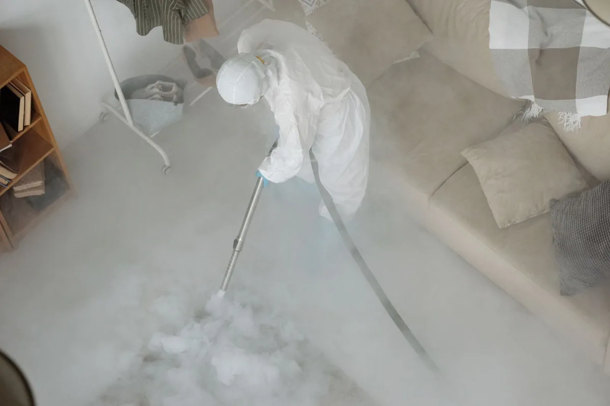 Biohazard cleanup technician in protective equipment, Ovid, MI